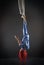 Athletic aerial circus artist with redhead in blue costume making tricks on the aerial silk