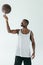 athletic african american basketball player spinning ball on finger,