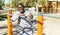 Athletic african american male performs warm-up exercises at chin-up bar