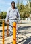 Athletic african american male performs warm-up exercises at chin-up bar