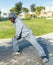 Athletic african american male performs warm-up exercises in park