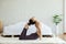 Athletic Asian woman practice yoga king cobra or Raja Bhudjangasana pose to meditation in bedroom after wake up