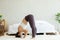 Athletic Asian woman practice yoga Spread foot stretching pose or Prasarita Padottanasana pose to meditation in bedroom