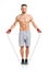 Athletic attractive man jumping on a rope on the white