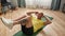 Athletic bald man smiling away, doing crunches on fitness mat while working out in living room at home