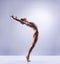 Athletic ballet dancer performing in a studio