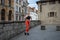 Athletic beautiful woman during fitness class in old european city