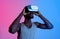 Athletic black guy wearing VR headset, doing virtual workout in augmented reality, neon lighting