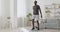 Athletic black man doing forward lunge exercises at home, training legs and hip muscles