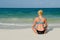 Athletic Blond Woman Meditating on Cancun Beach
