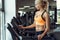 Athletic blond woman running on treadmill at gym.