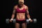 Athletic bodybuilder woman with dumbbells.beautiful blonde girl with muscles
