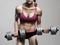 Athletic bodybuilder woman with dumbbells.girl with muscles