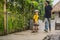 Athletic boy learns to skateboard with a trainer in a skate park. Children education, sports