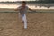 Athletic capoeira performer making movements on the beach