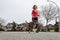 Athletic Caucasian Adult Woman Running outside with a Boxer Dog.