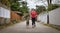 Athletic Caucasian Adult Woman Running outside with a Boxer Dog.