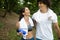 Athletic couple friend drinking water after running