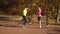 Athletic couple jumping on sports ground in autumn