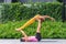 Athletic couple practicing acro yoga or yoga partner together in fitness park