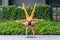 Athletic couple practicing acro yoga or yoga partner together in fitness park