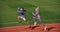 athletic couple of sprinters run on running track at stadium, success