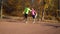 Athletic couple stretching legs on sports ground in pair on sunny day