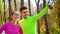 Athletic couple taking funny selfie after jogging in autumn park