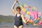 Athletic elderly woman runs along the waves on a summer sunny day