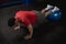 An athletic and fit asian man does pushups on a stability ball. Abdominal and core exercise and workout. Overhead shot