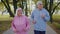 Athletic fitness senior elderly sport runner man woman training cardio workout in park at morning