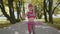 Athletic fitness toddler girl training playing twisting Hula hoop circle ring around waist in park