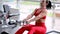 Athletic fitness woman doing exercises for back and posing in the gym