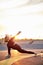 Athletic flexible woman is stretching body during yoga exercises