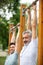 athletic friends in sportswear exercising on horizontal bars