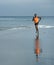 Athletic full body portrait of young attractive and fit black afro American man running on the beach doing Summer fitness jogging