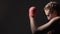 Athletic girl with braids boxing in the gym, Muay Thai workout, sport and hobby