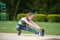 Athletic girl performs hamstring and stretching exercises