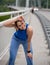 Athletic girl in sportswear wiping sweat from forehead exercusung outdoors