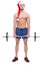 Athletic guy with a naked torso and a santa hat is holding a barbell. Isolated.