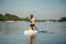 Athletic handsome man paddles on a sup board on the river. Training on a rowing board on a sunny summer day. sup board as a hobby