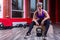 An athletic and happy young blonde female posing with dumbbells in a gym.