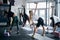 Athletic ladies exercising with dumbbells at morning gym class