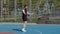 Athletic lebanese man in sportswear skipping rope doing jumping exercises on basketball court