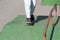 Athletic legs of a teenager ride a skateboard on a sports field, on the street