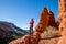 Athletic man with arms folded standing among red rock formations in Southern Utah