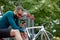 Athletic man in a bar park checking his phone. He is wearing a sun glasses.