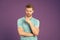 Athletic man in blue tshirt on violet background. Man with beard on unshaven face skin on purple backdrop. Fashion model