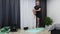 Athletic man does gymnastics exercises on mat. Young energetic male exercising on yoga mat. Fitness trainer doing stretch training