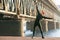 Athletic man doing stretching exercises, outdoor. Active male working out outside on the background of the bridge